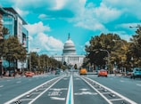 wide road with vehicle traveling with white dome building
