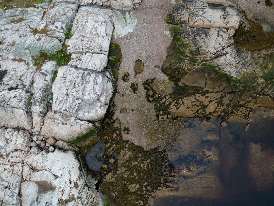 aerial photography of rock formations near body of water