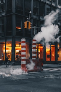 red-and-white striped post near concrete building during daytime