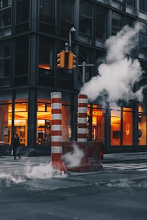 red-and-white striped post near concrete building during daytime