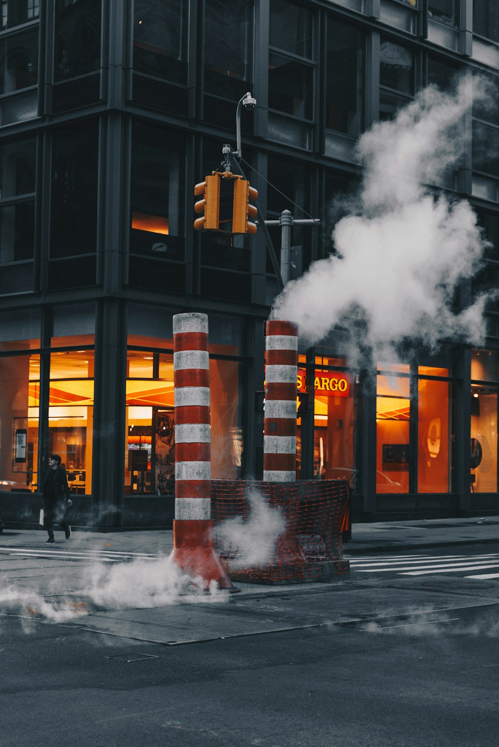 red-and-white striped post near concrete building during daytime