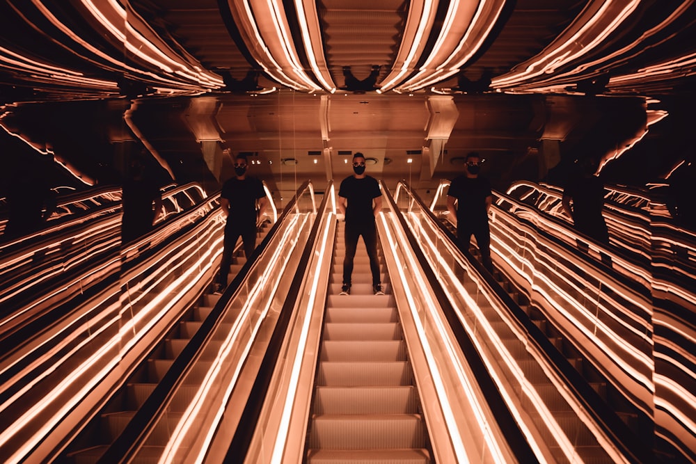 person on mirrored escalator