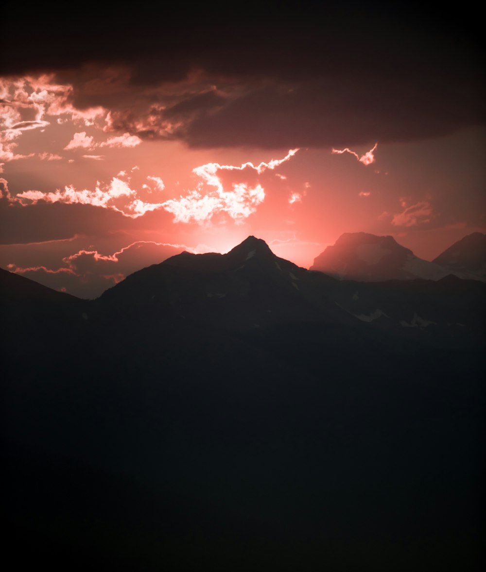 silhouette of mountain under red sky panoramic photography