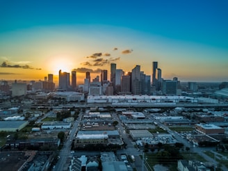 City skyline with commercial buildings during sunset.