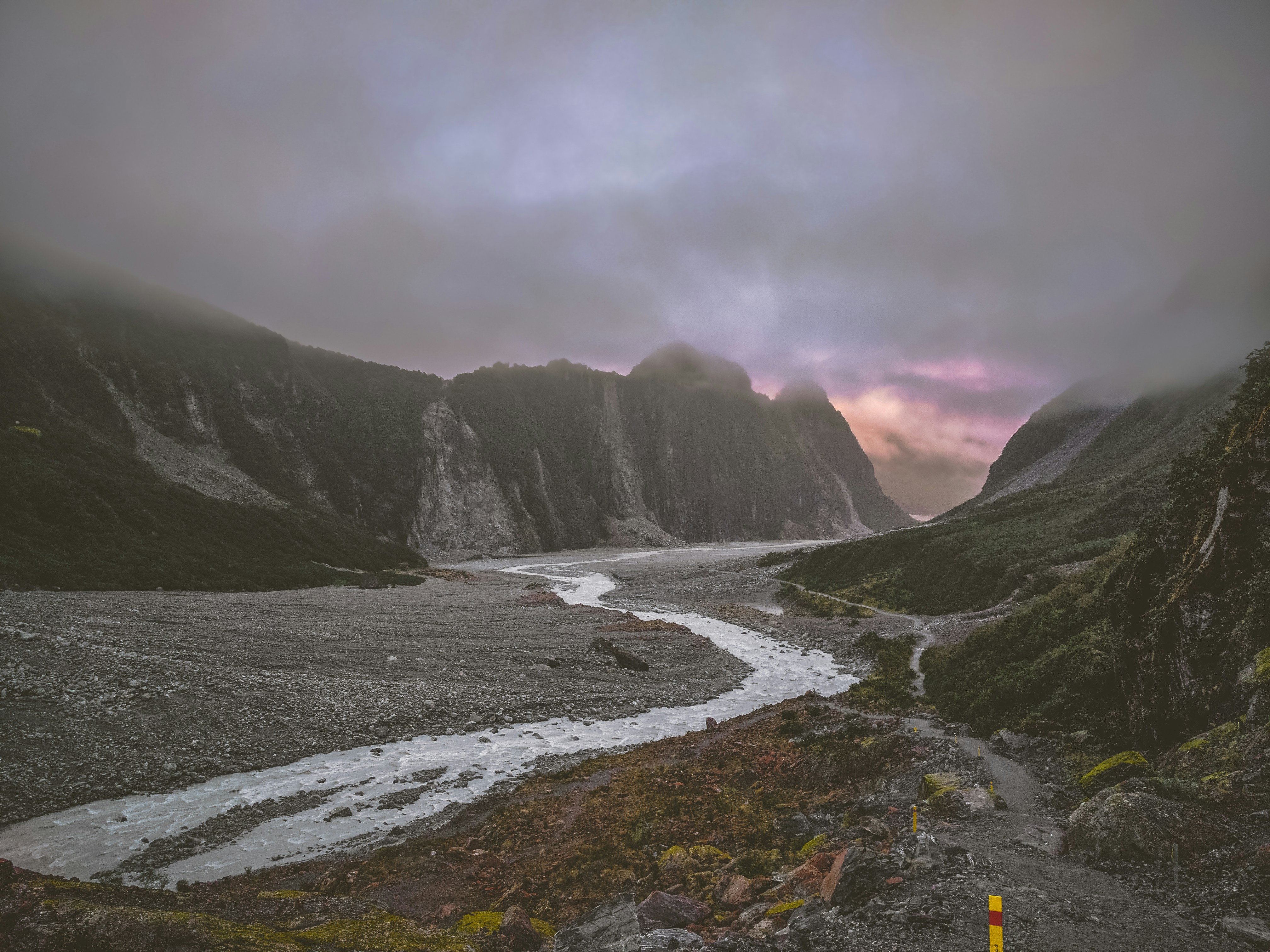 river in between brown hill