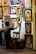 Portrait of a thoughtful fan admiring artwork in a cozy studio.
