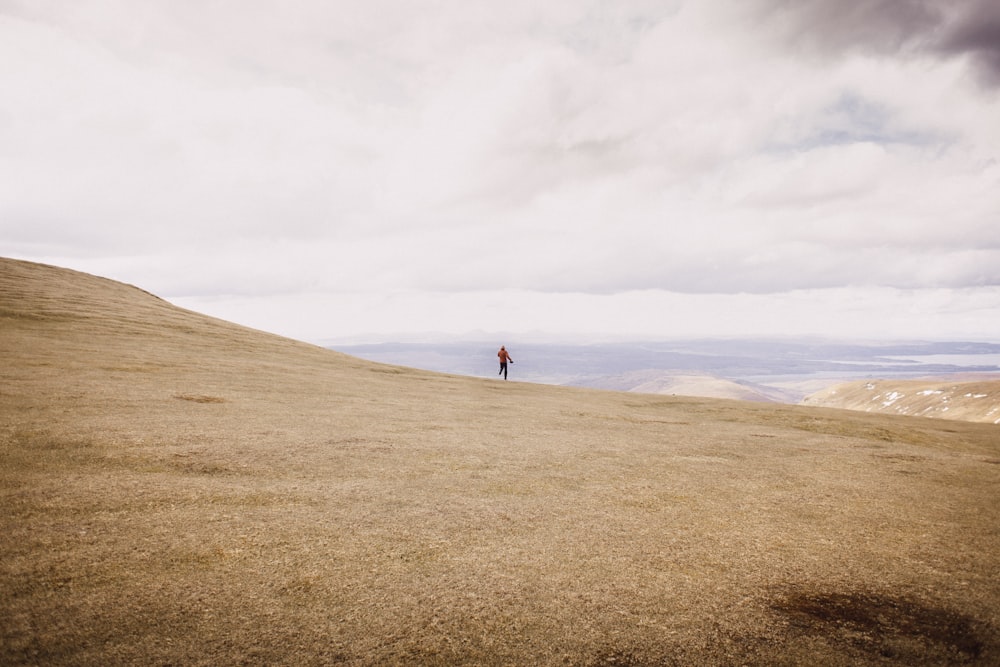 person walking on brown surface during daytime