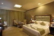 A cozy, elegantly styled corner of one of Berwick Bridges’ luxury hotel rooms featuring soft lighting and plush bedding.