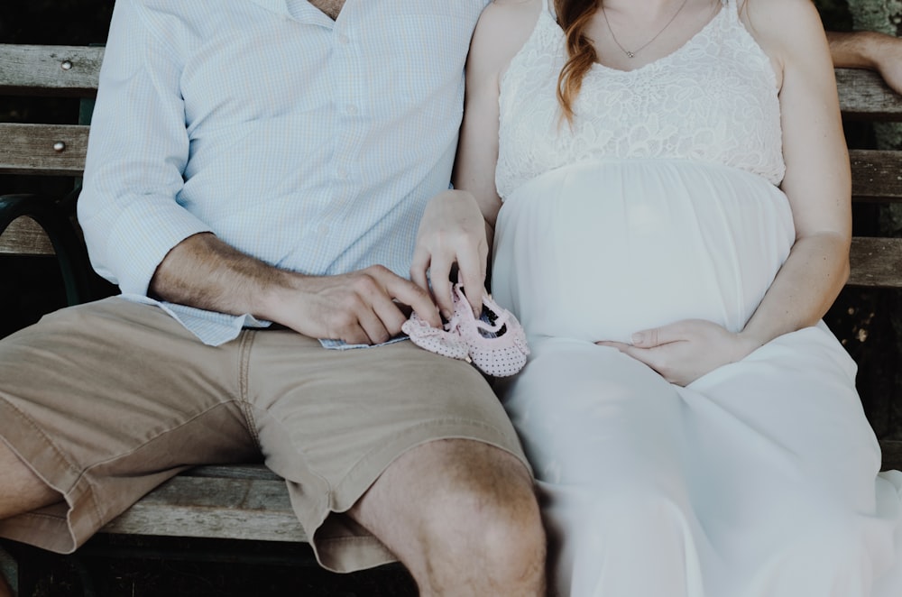 close-up photo of man and woman sitting on bench