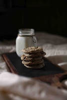 Chocolate chip cookies arranged invitingly on a rustic wooden table with soft natural light.