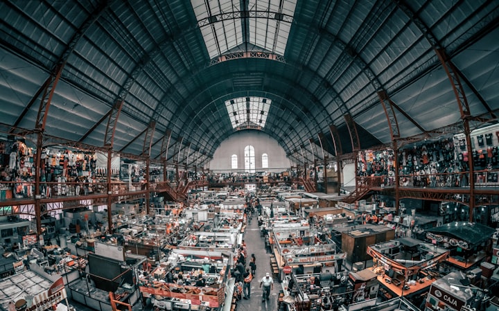 A busy indoor maketplace with multiple vendors