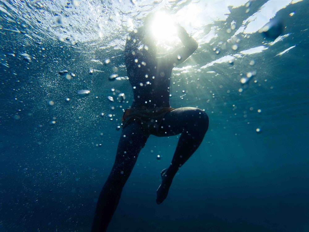 person under the body of water