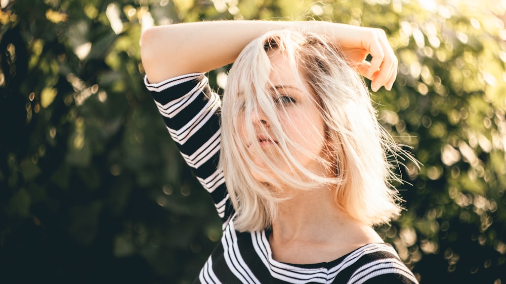 Shallow focus photography of woman in black and white striped top.