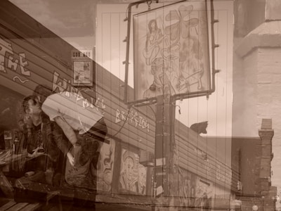 An artistic double exposure image combining street art, featuring paintings and graffiti on a building, with the scene of a couple in a casual setting. The mural includes abstract and figurative elements, while the couple appears to be sitting at an outdoor cafe or bar. The overall composition blends urban art with an intimate social moment.