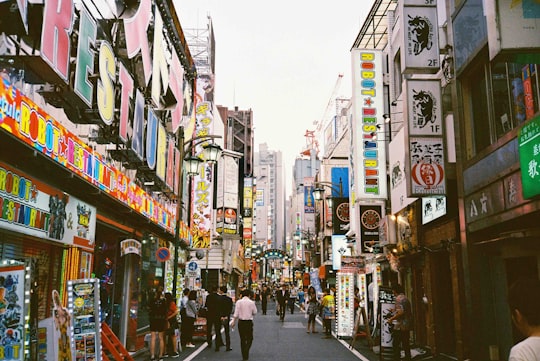 people walking between high-rise buildings in Shinjuku Japan