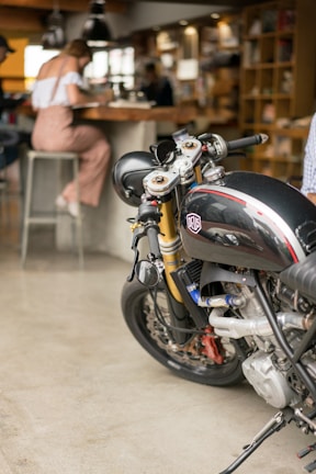 A classic cafe racer parked outside Schiro Moto, showcasing its sleek lines and polished chrome.