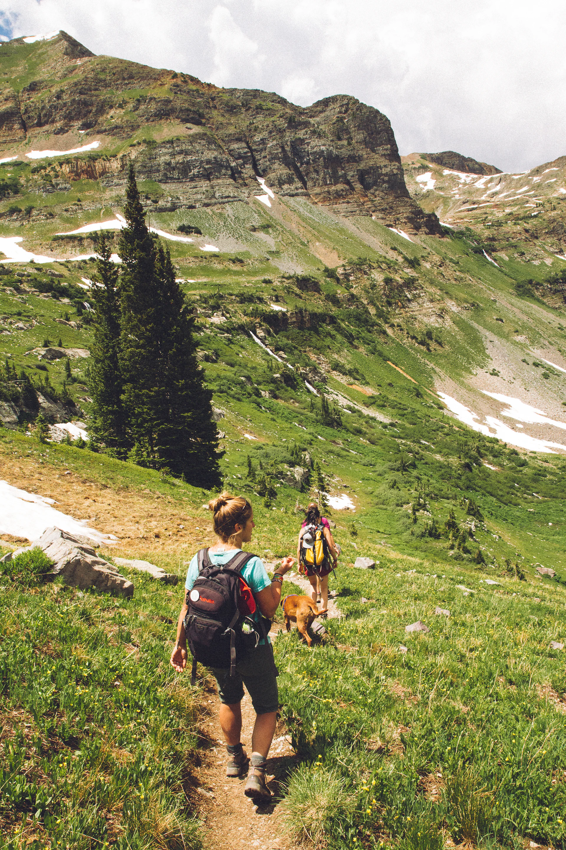 A loaded backpacking pack resting on granite at a high mountain pass