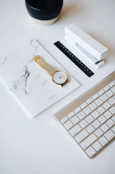 Elegant black and gold-themed workspace with gold coins and a notebook.
