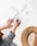 person holding ballpoint pen writing on white paper