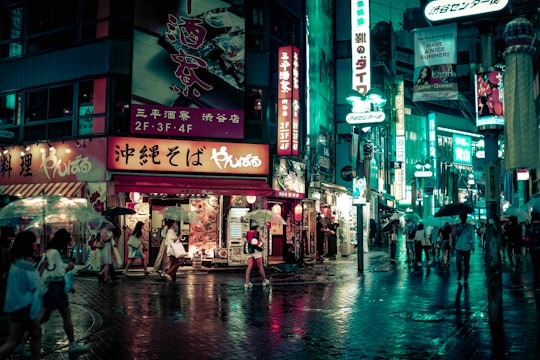 people walking near buildings at night in Yanbaru やんばる 渋谷店 Japan