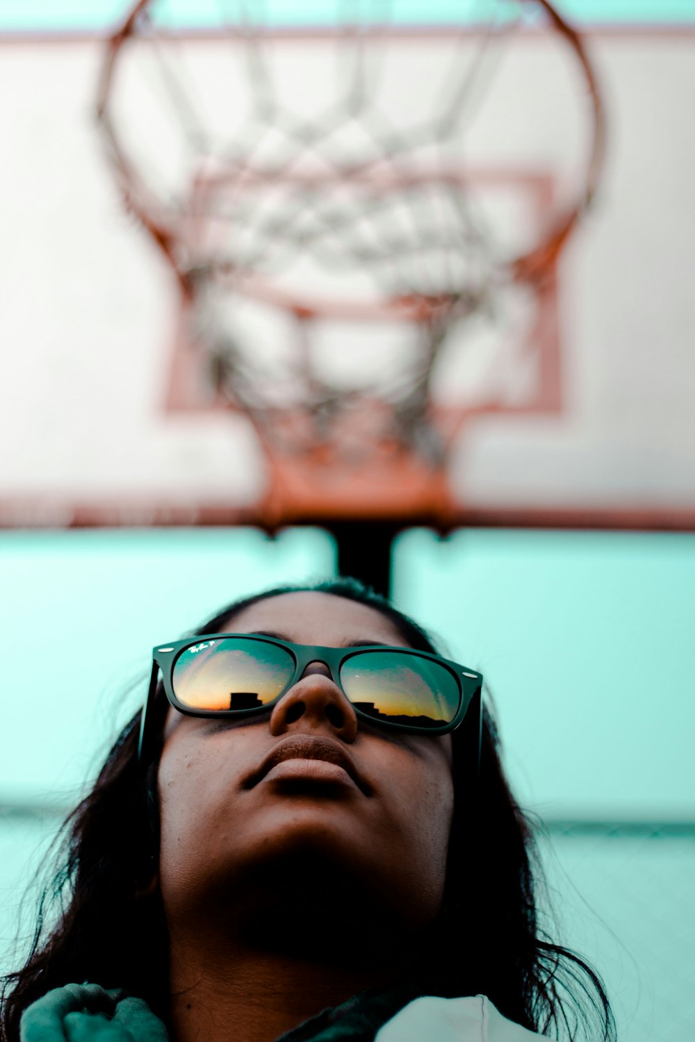 person wearing black Ray-Ban Wayfarer sunglasses with black frames in worm's eyeview photography during daytime