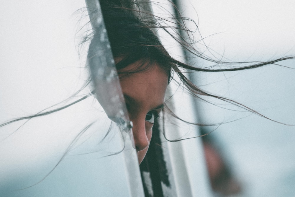 girl sticking her head in car of window