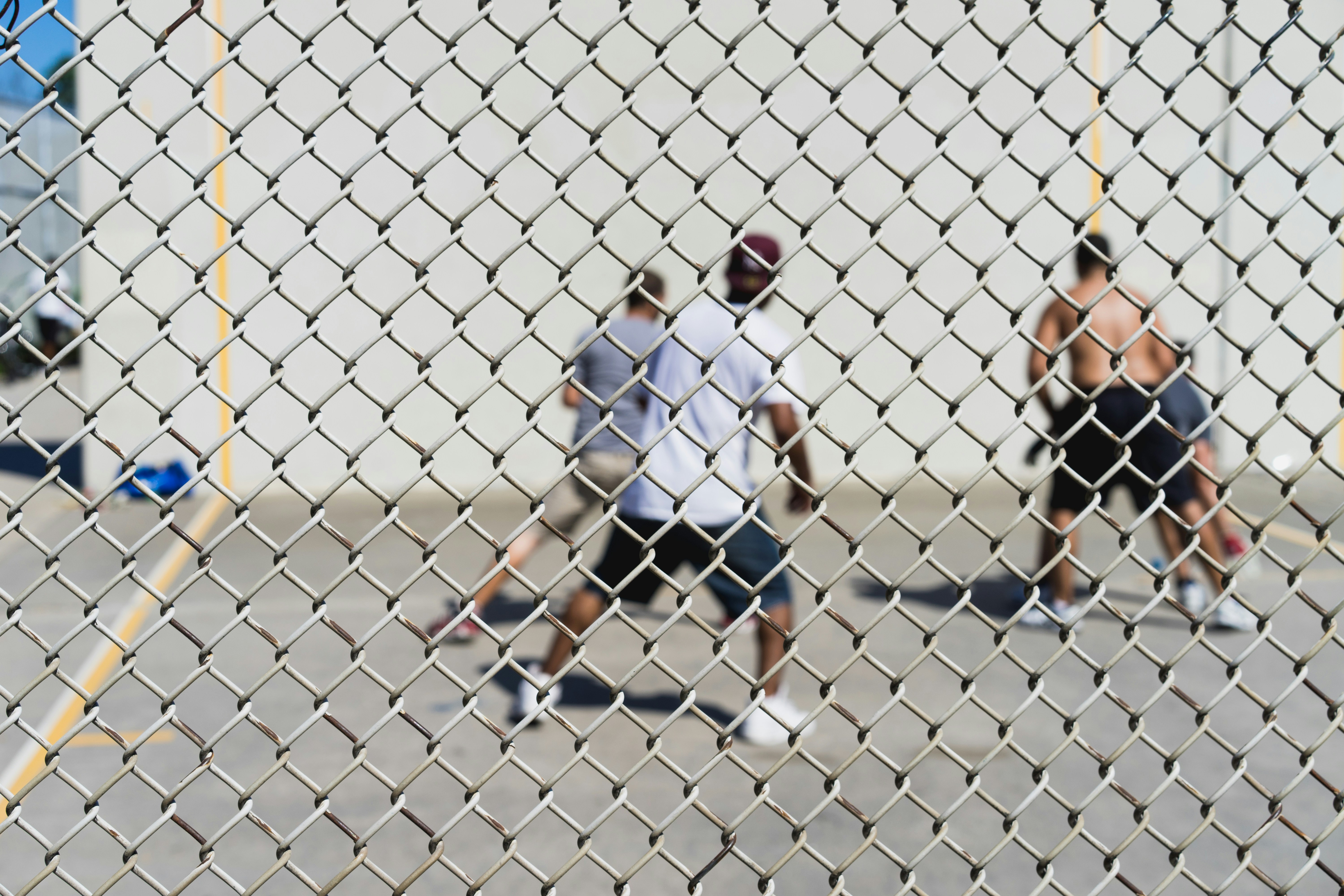 four men playing basketball