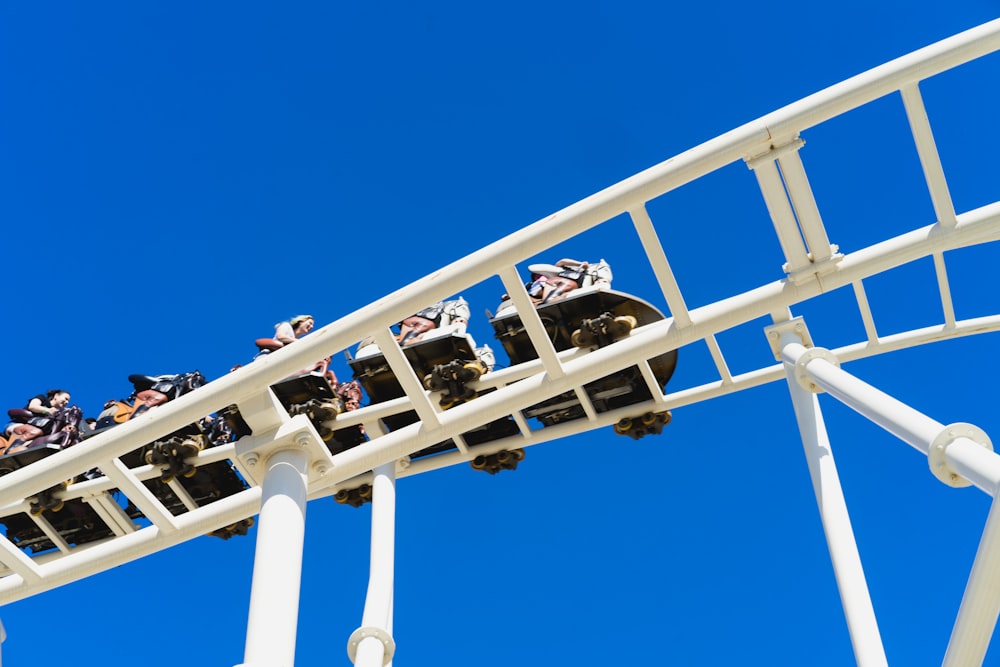 low-angle photo of people riding on roller coaster