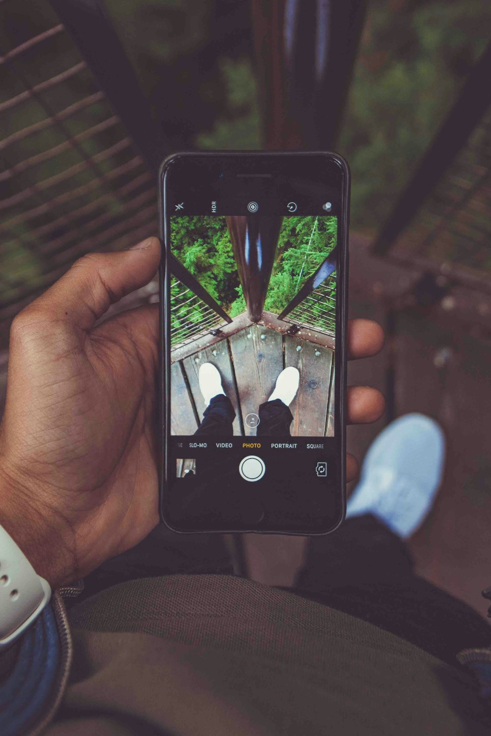 person holding iPhone 6 with black case