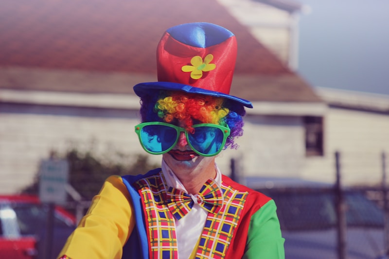 shallow focus photography of human wearing clowns costume