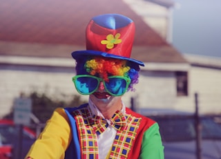 shallow focus photography of human wearing clowns costume