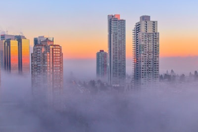 high-rise buildings surrounded by fog urban teams background