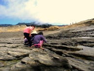 Children from a vulnerable community learning about geology outdoors with hands-on activities.