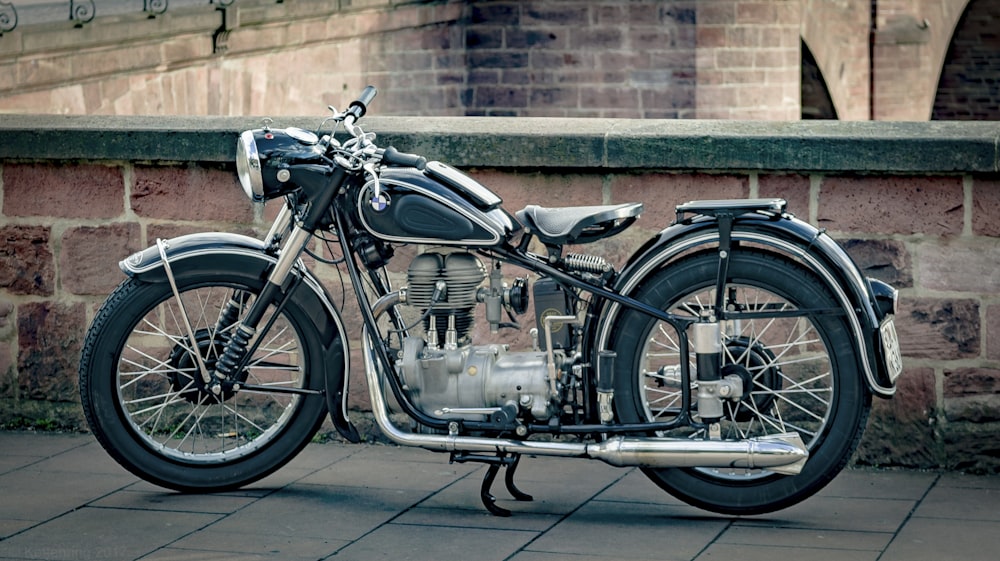 black standard motorcycle standing near wall