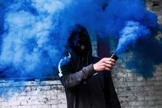 Volunteers in black hoodies and masks handing out meals under streetlights with subtle smoke and urban textures.