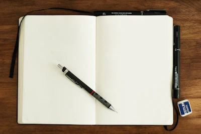 Photo: Mike Tinnion / Unsplash black and silver retractable pen on blank book
