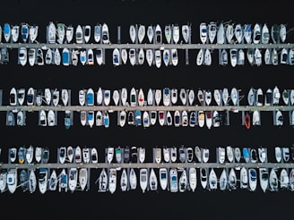 An aerial view of multiple boats docked at a marina.