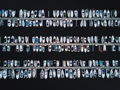 Aerial view of various boats docked at a marina.