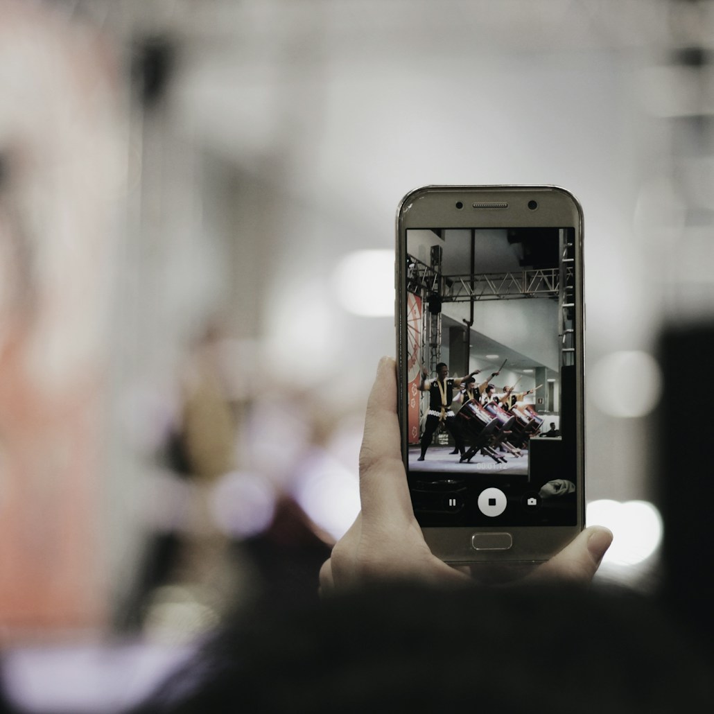 selective focus photography of person using silver smartphone