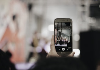 selective focus photography of person using silver smartphone