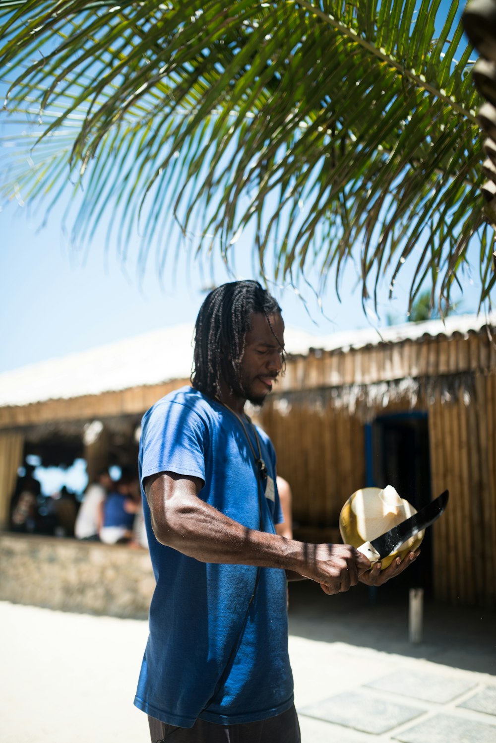 man peeling coconut