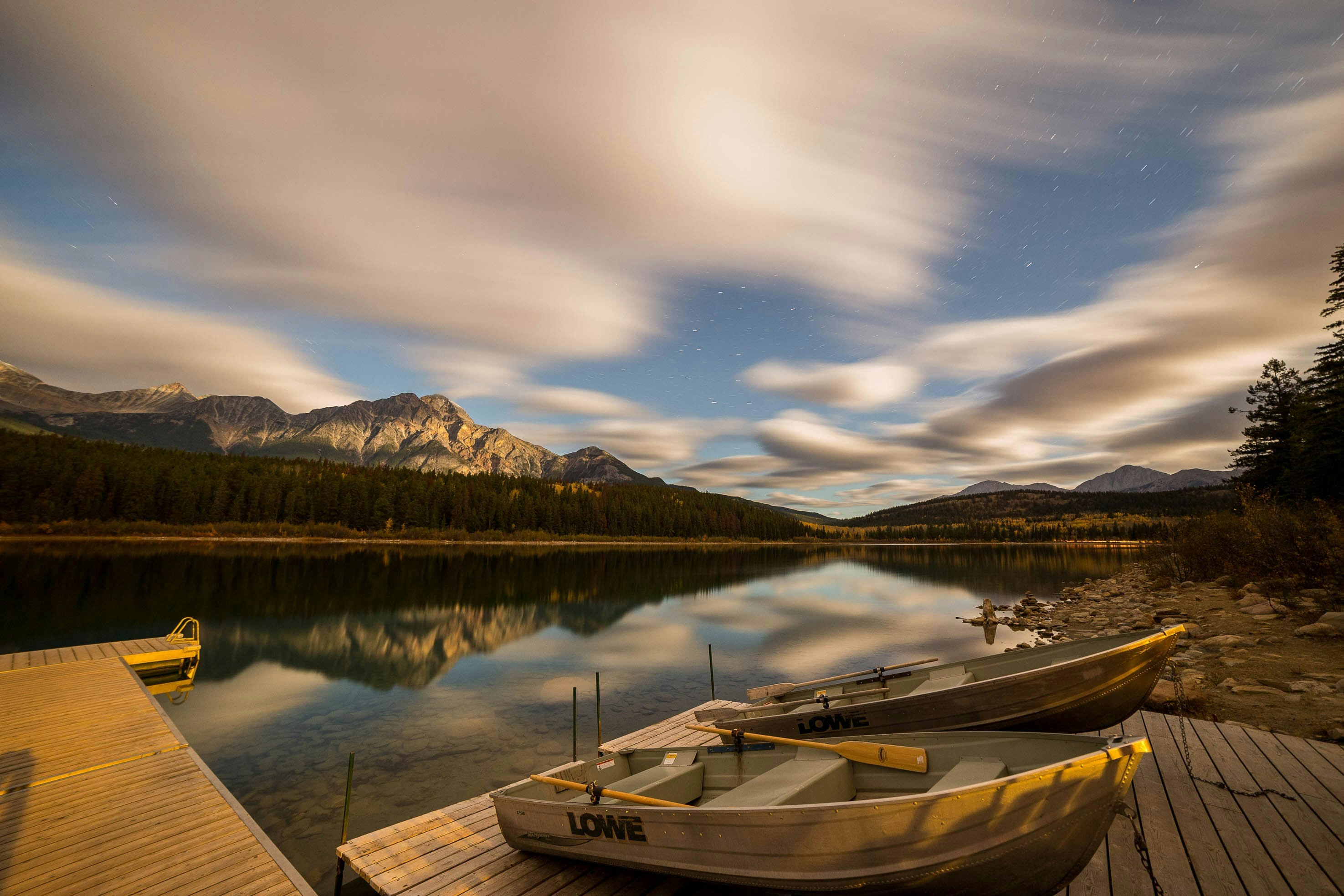 two brown dinghy boats on dock