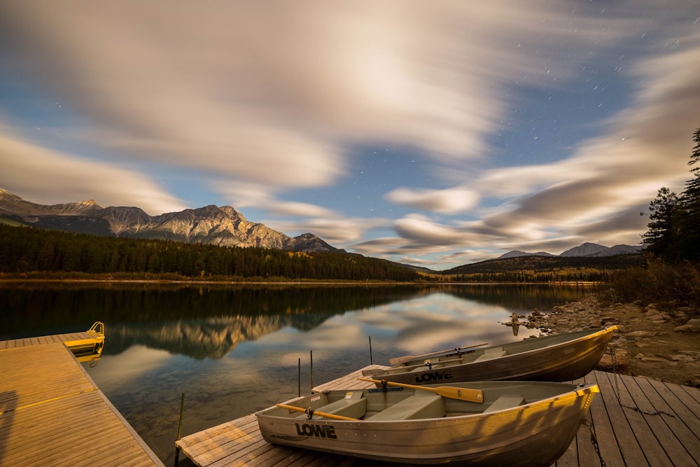 two brown dinghy boats on dock