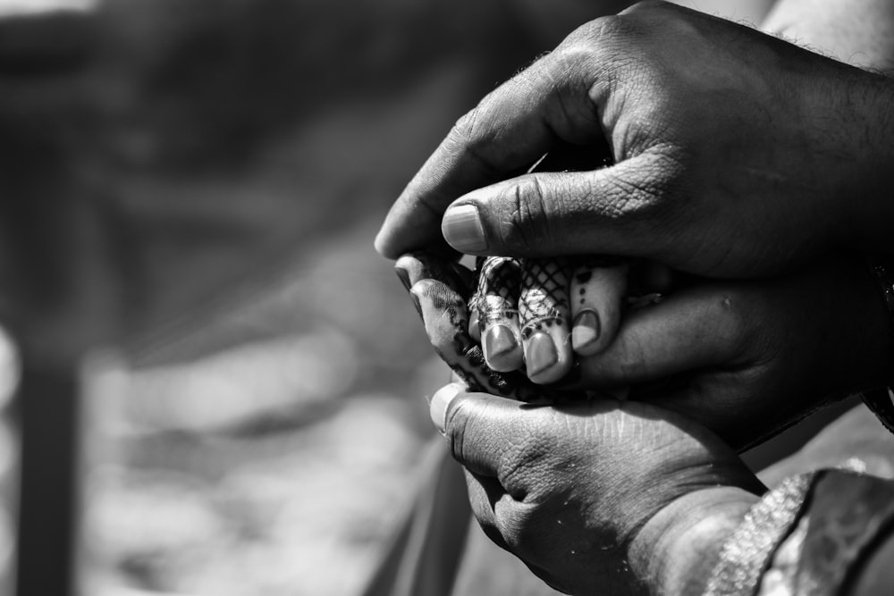 grayscale photography of human hands