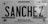 A black and white license plate from Michoacán, Mexico, displaying the name 'SANCHEZ' in bold letters. The plate includes a map outline of the region and text reading 'Transporte Privado Automovil'. Various official symbols and serial numbers are visible.