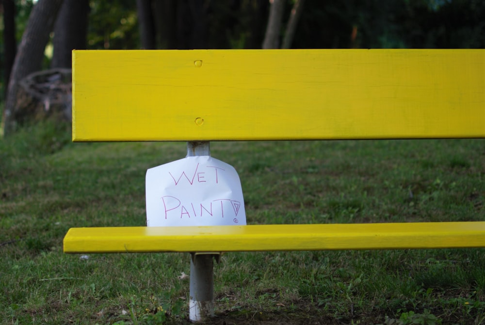 newly painted bench with signage wet paint