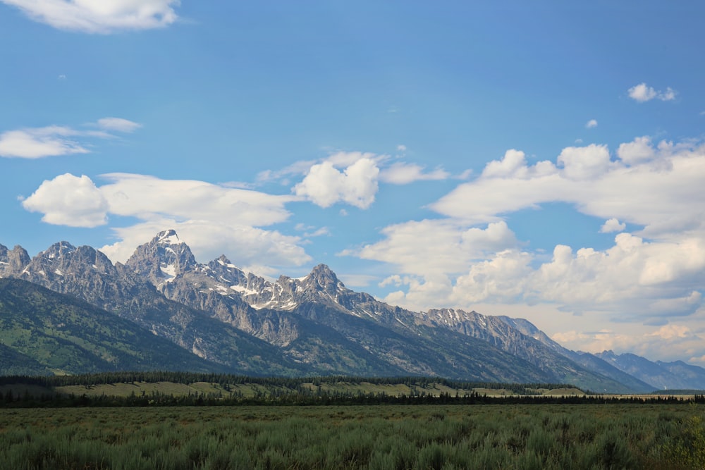 gray rocky mountains under white cloudy sky during daytime