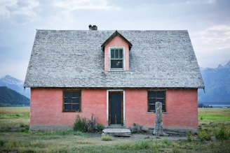 red and gray brick house under gray sky