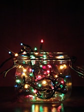 A storage jar filled with neatly packed holiday lights.
