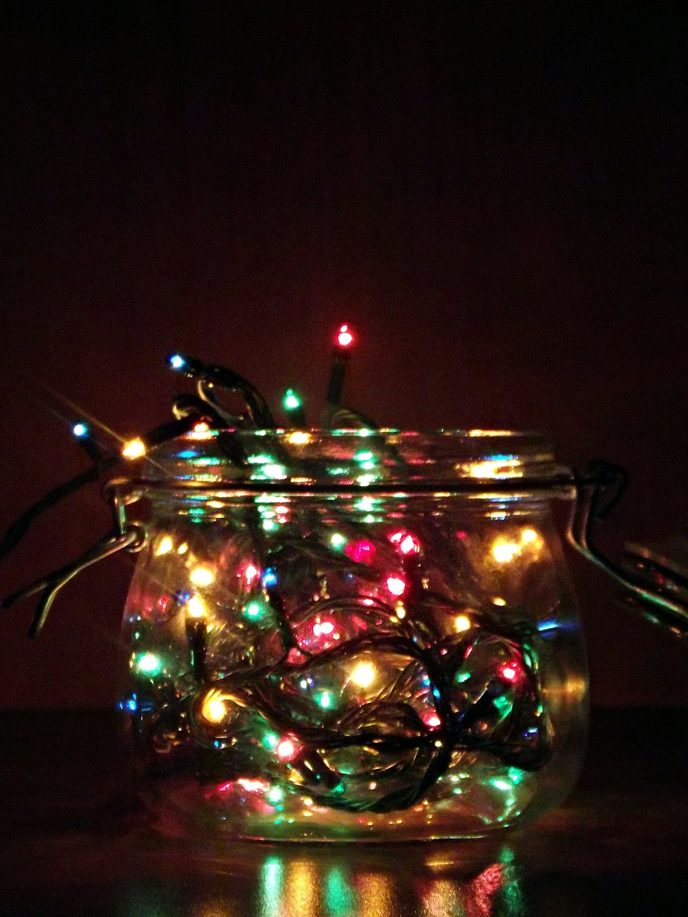 A glass jar containing Christmas tree lights.